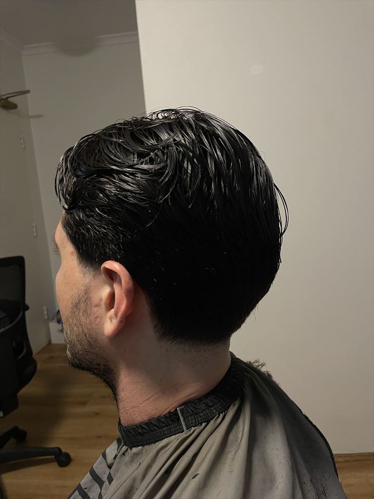 Swept-back cut with a low taper at the neckline